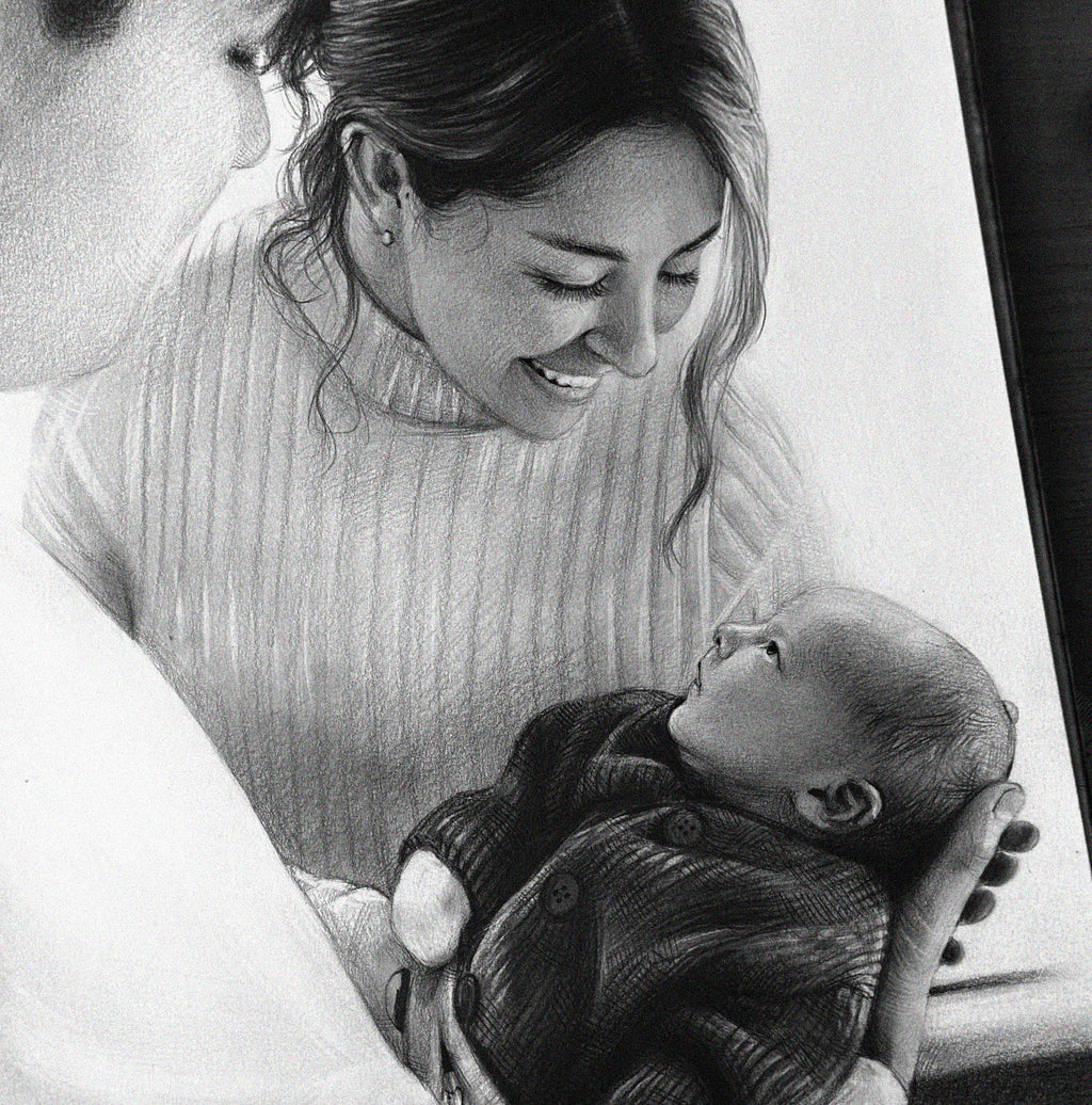 A close-up of a detailed graphite drawing showing a smiling mother in a ribbed turtleneck sweater gently looking down at the baby she is holding in her arms. The baby, wearing a dark knitted onesie, is lying on its back and looking up at its mother. The drawing conveys the love and bond between them.