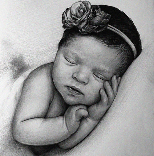 Detailed black and white graphite pencil drawing of a peacefully sleeping newborn baby. The baby is wearing a floral headband and has its tiny hands resting gently against its cheek.