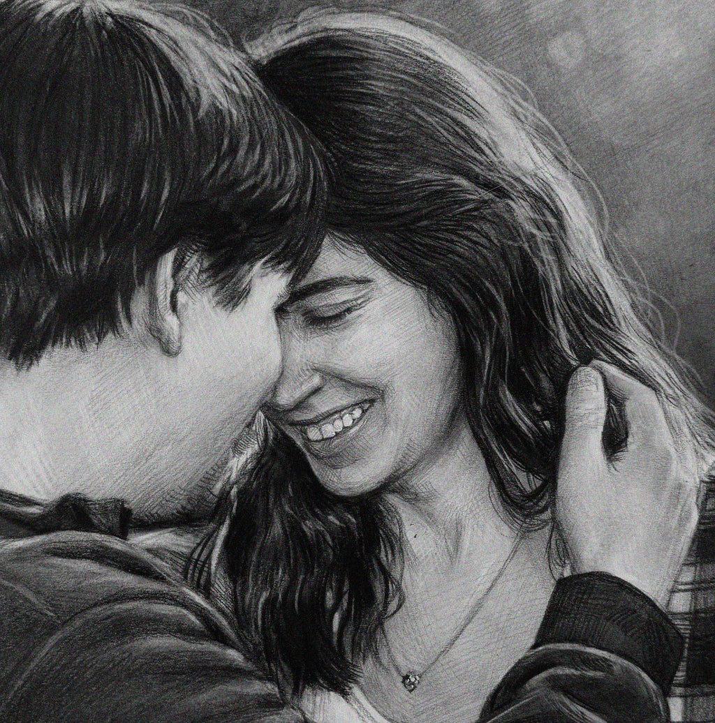 A detailed, close-up black and white pencil drawing of an intimate embrace between a happy man and woman. Their foreheads are touching, and the smiling woman, her eyes closed in joy, has her long wavy hair gently held by the man's hand. The drawing style uses soft charcoal or graphite shading on a textured paper surface. Both subjects are casually dressed and looking lovingly towards each other. The background is softly blurred.