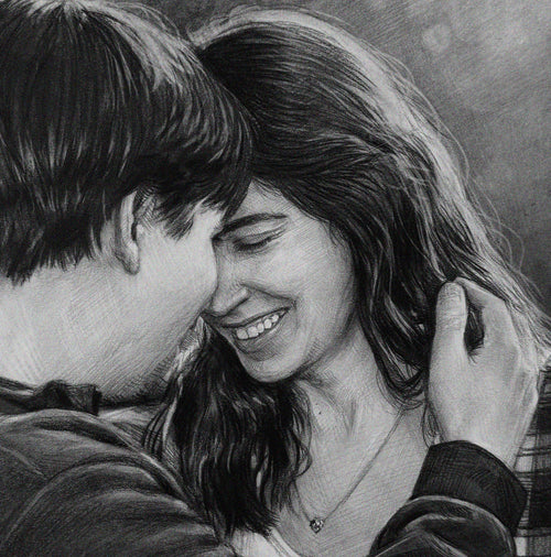 A detailed, close-up black and white pencil drawing of an intimate embrace between a happy man and woman. Their foreheads are touching, and the smiling woman, her eyes closed in joy, has her long wavy hair gently held by the man's hand. The drawing style uses soft charcoal or graphite shading on a textured paper surface. Both subjects are casually dressed and looking lovingly towards each other. The background is softly blurred.