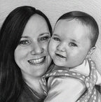 A realistic black-and-white sketch portrait of a woman and a baby, drawn with a graphite pencil. The woman, with long dark hair, is smiling broadly, showing her teeth as she leans her face close to the child. The infant, with sparse hair and large eyes, looks at the viewer with a slight smile, dressed in a spotted onesie. The portrait captures a tender moment and the details of the paper’s texture and pencil hatching.